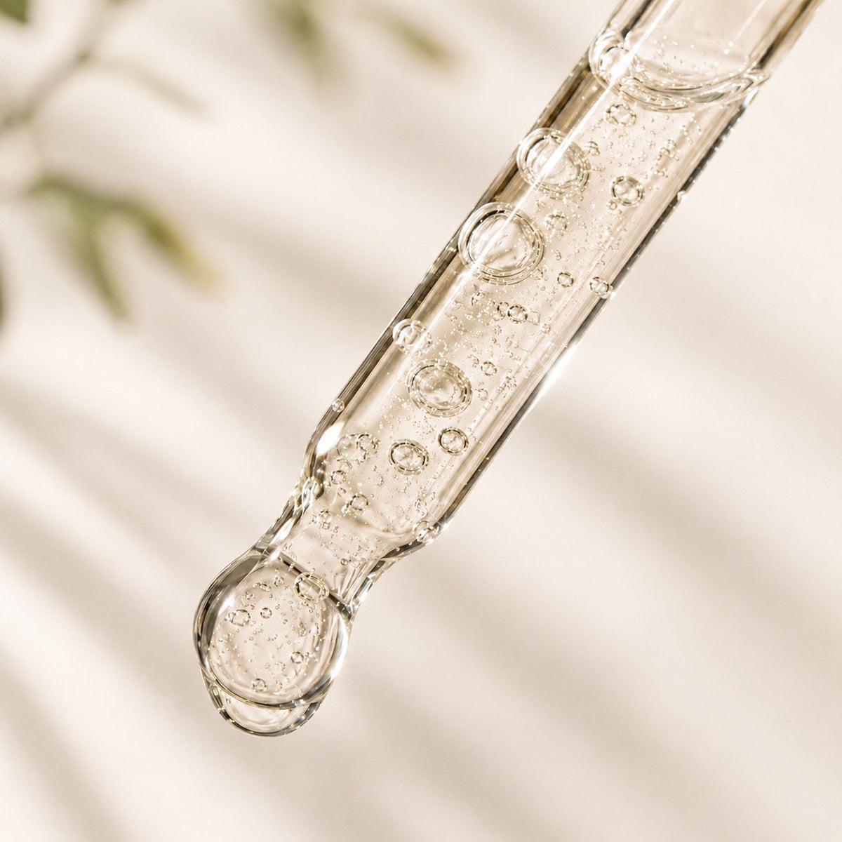 Close-up of Clarity Serum dropper with liquid droplets